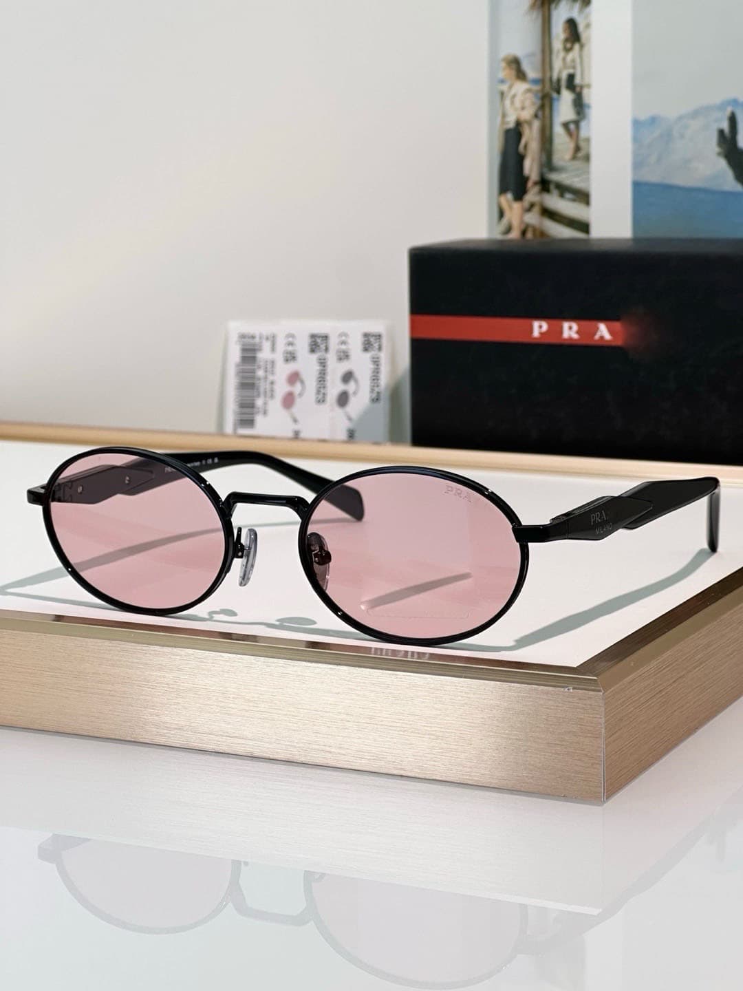 Black frame, pink lens